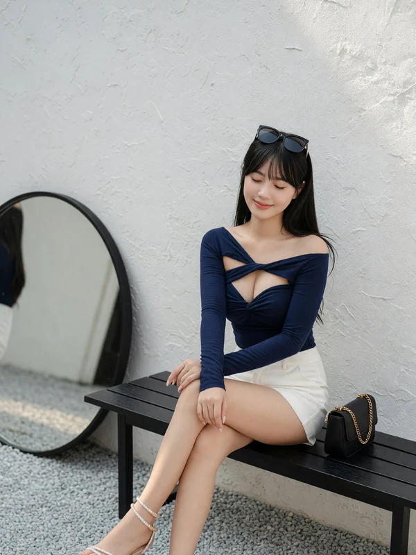 Blue outfit portrait beside a stone bench